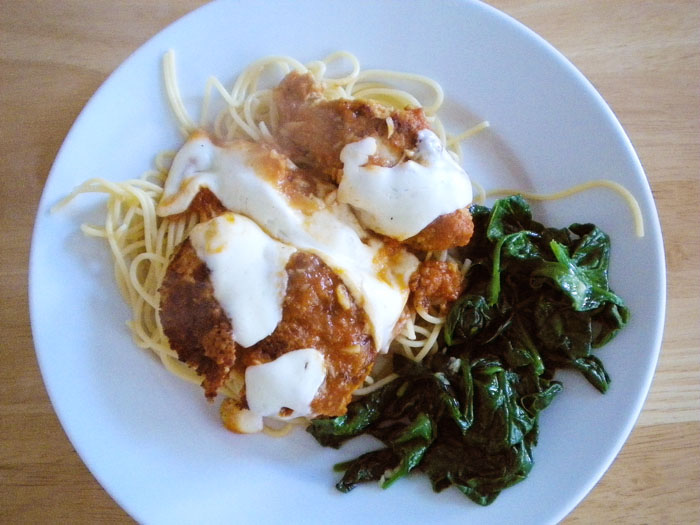 Chicken parmesan with sauteed spinach.